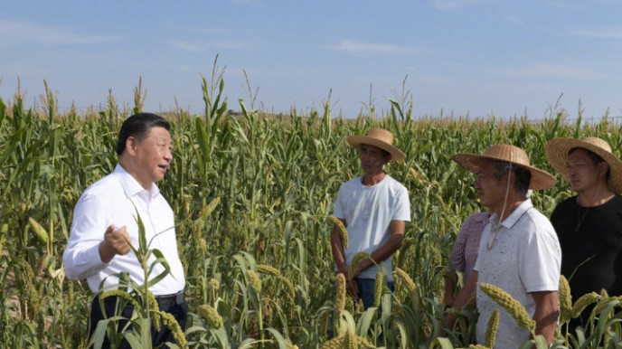 Xi chats with villagers in the fields in Shaanxi Province