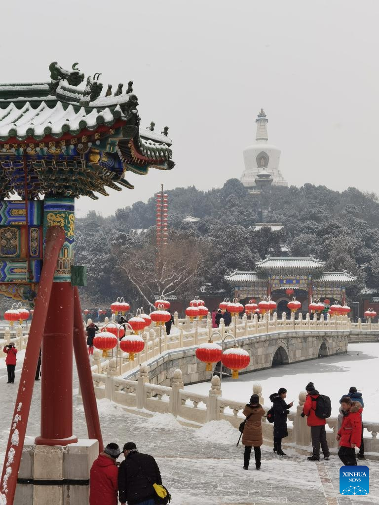 People enjoy snow scenery at scenic spots in Beijing