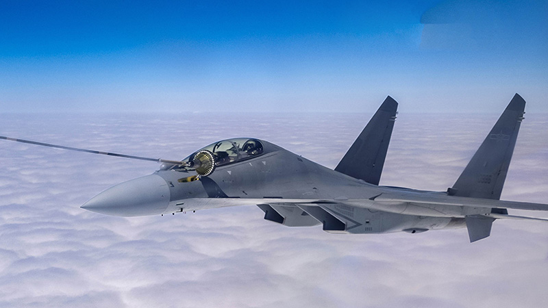 Pilots maneuver fighters in aerial refueling