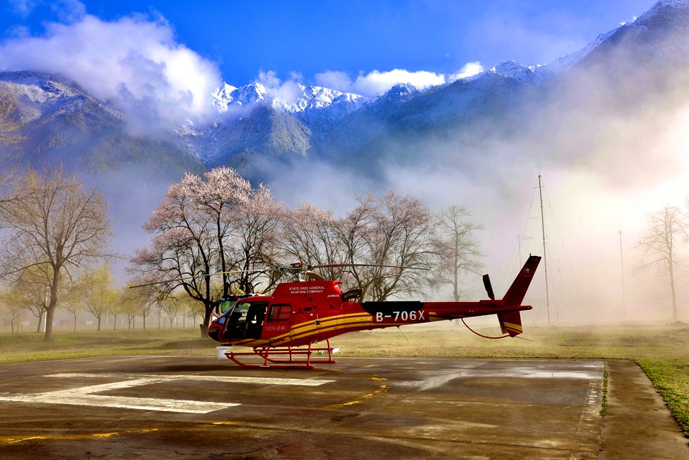 Helicopter rises on high to check power line in SW China’s Tibet