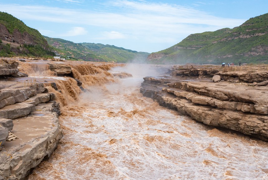 Rainbow appears over Hukou Waterfall on Yellow River