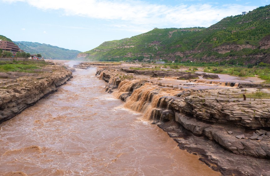 Rainbow appears over Hukou Waterfall on Yellow River