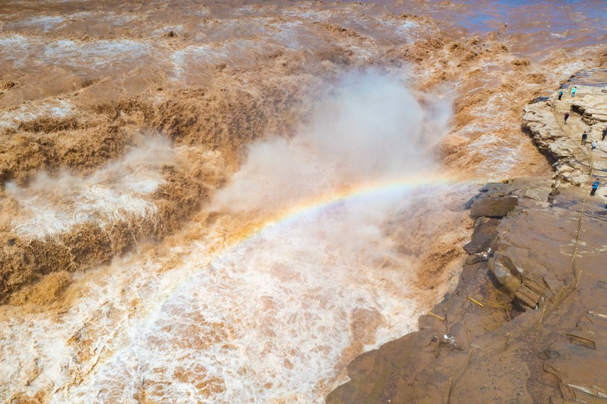 Rainbow appears over Hukou Waterfall on Yellow River