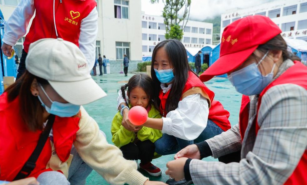 Volunteers open tent classrooms for children at quake relief shelter in Sichuan