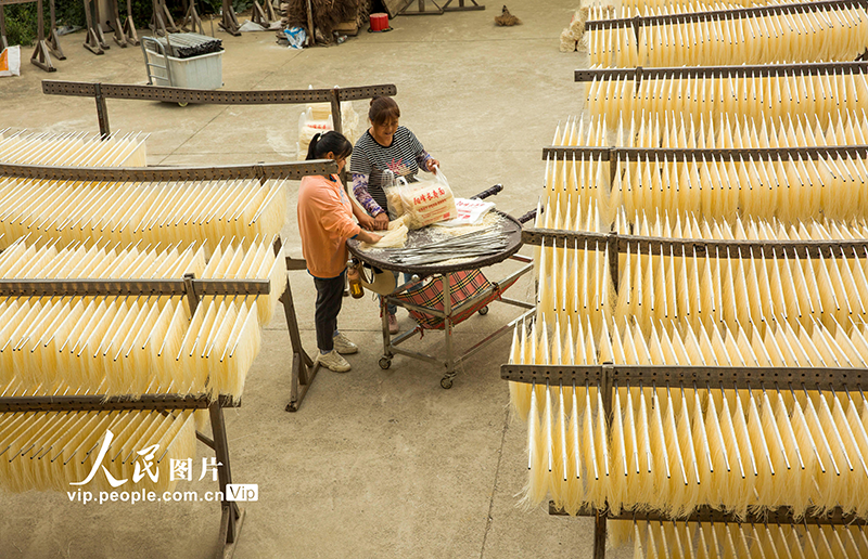 Residents dry fresh noodles at village in China's Jiangxi