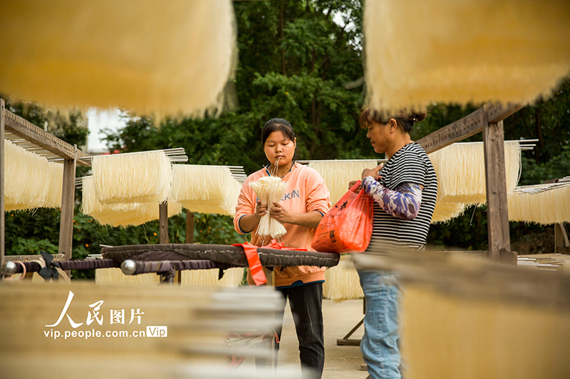 Residents dry fresh noodles at village in China's Jiangxi