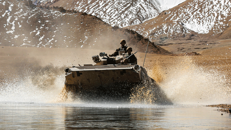 Armored vehicle wades through water obstacle