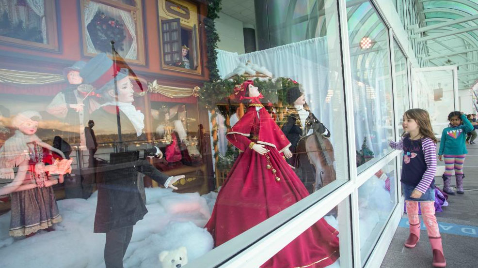 People view vintage Christmas window displays in Vancouver
