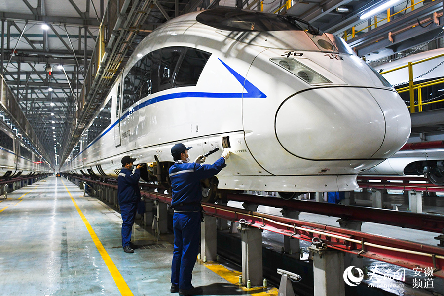 Young maintenance worker checks bullet trains for Spring Festival travel rush