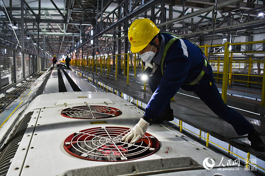 Young maintenance worker checks bullet trains for Spring Festival travel rush