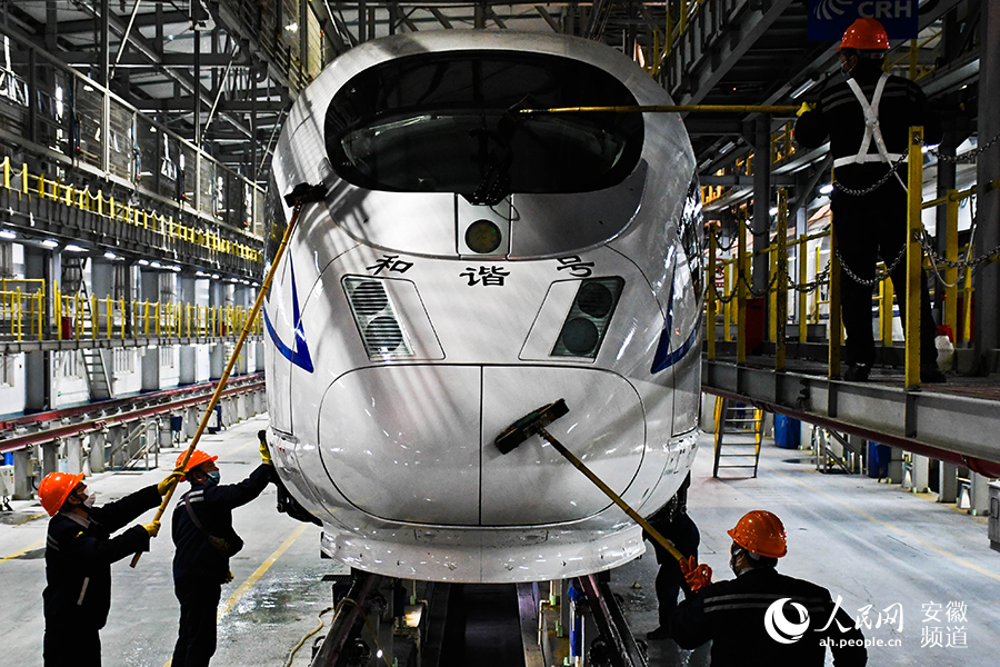 Young maintenance worker checks bullet trains for Spring Festival travel rush