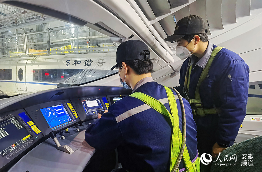 Young maintenance worker checks bullet trains for Spring Festival travel rush