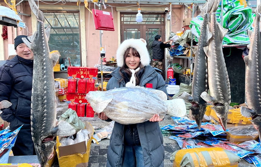 Colorfully lit snow sculptures, busy fish market add festive atmosphere in China's easternmost city