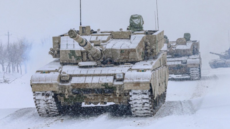 Main battle tanks rumble in snow-covered area