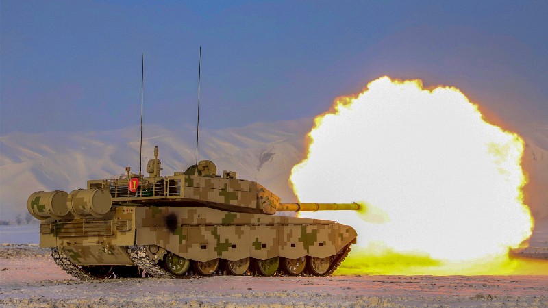 Main battle tank fires at mock targets on plateau