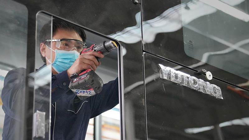 Staff busy on assembly line to catch overseas orders of new energy buses in Yutong, C China