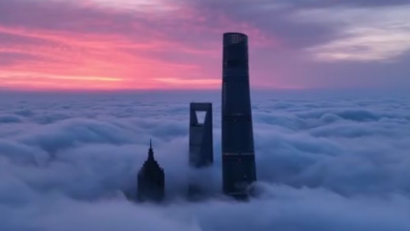 Shanghai skyscrapers soar above a sea of clouds at dawn