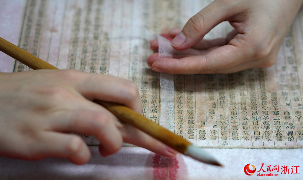 Repairers bring damaged ancient books back to life