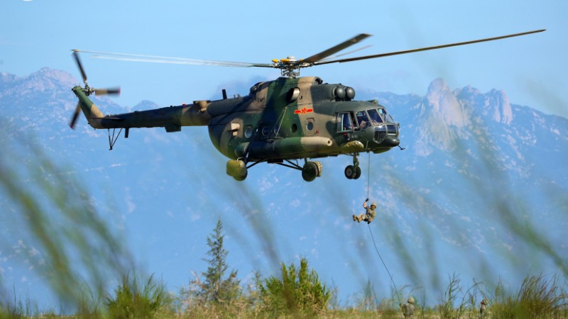 Soldiers fast rope from transport helicopters