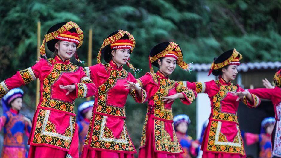 Yi brides in beautiful ethnic clothing on high-speed train