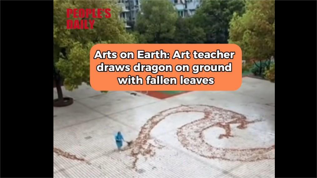 Art on earth: Teacher draws dragon on ground with fallen leaves