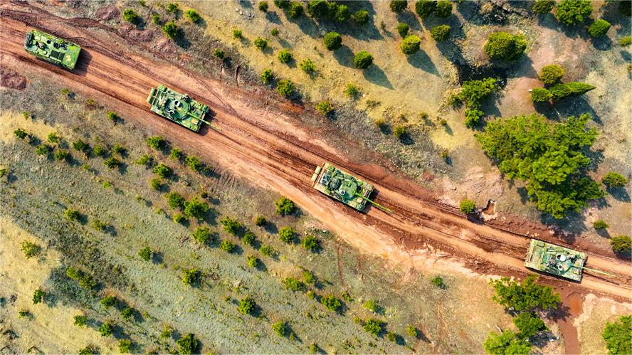 Armored vehicles rumble on field