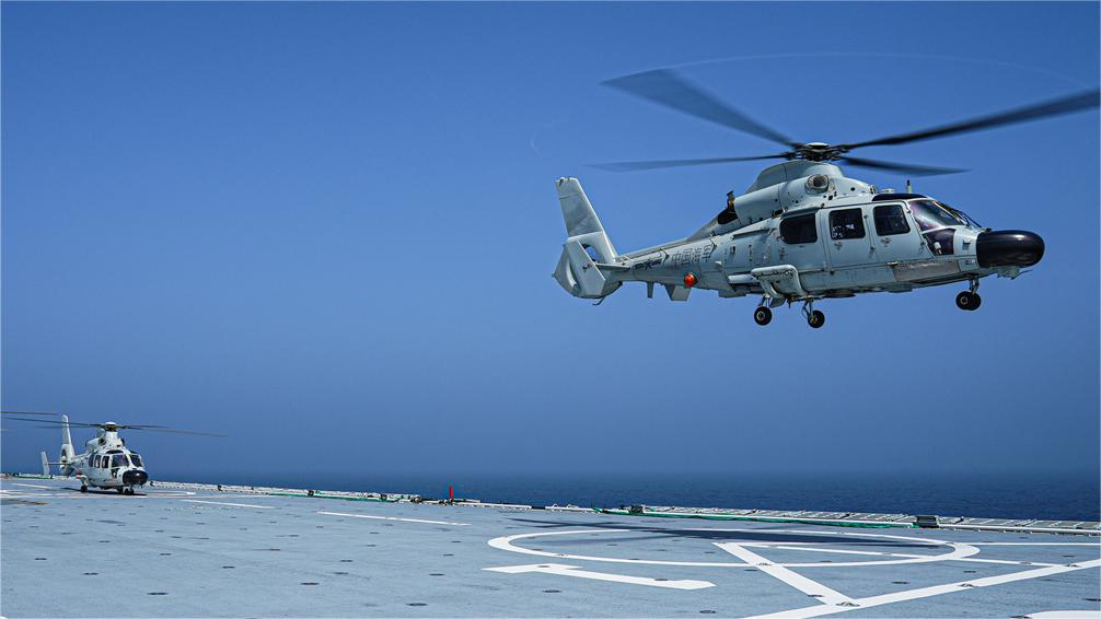 Chopper lifts off from landing ship
