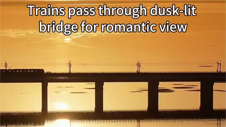 Trains pass through dusk-lit bridge for romantic view