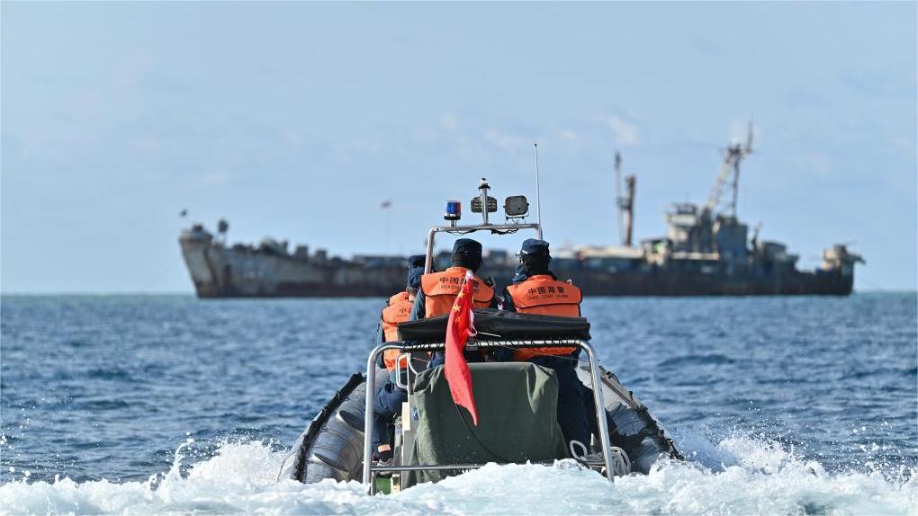 Philippine navy personnel on illegally grounded ship destroy Chinese fishing nets