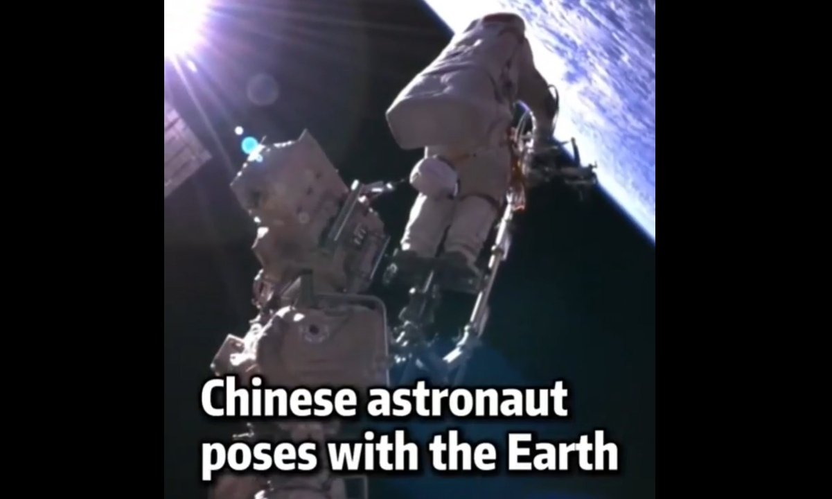Chinese astronaut poses with the Earth