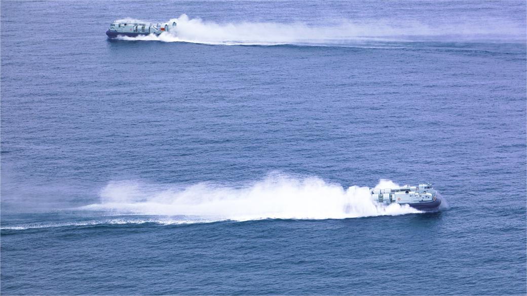 Air-cushioned landing craft travel in formation