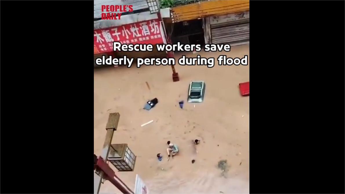 Rescue workers save elderly person during flood