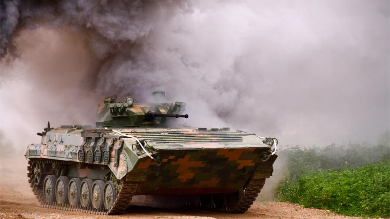 Armored vehicles engage in tactic assessment