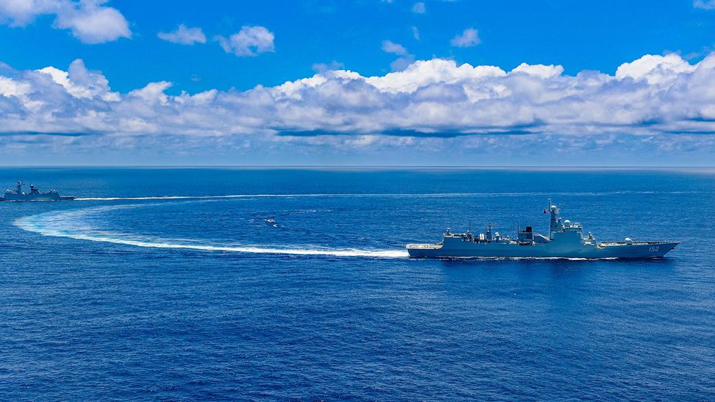 Naval vessels sail in formation