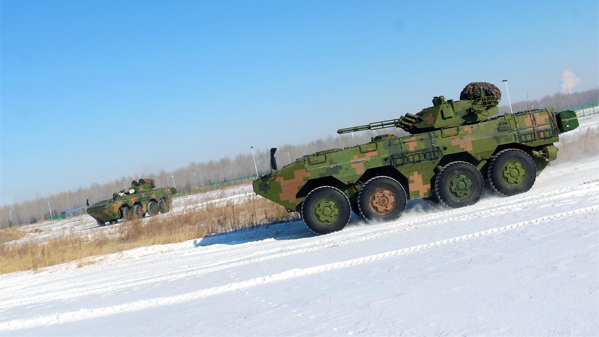 Infantry Fighting Vehicles race across snowy terrain