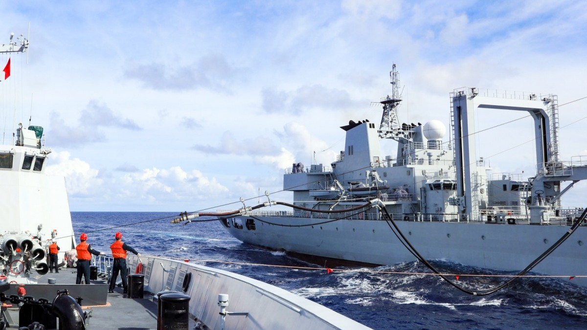 Naval vessels conduct alongside replenishment at sea