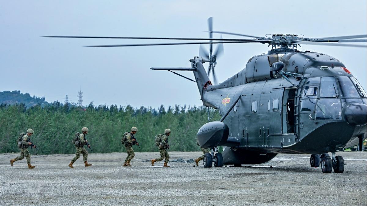 Helicopters conduct multi-subject flight training over the sea
