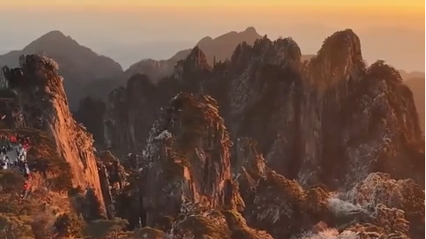 Huangshan Mountain glows in winter sunrise after fresh snowfall