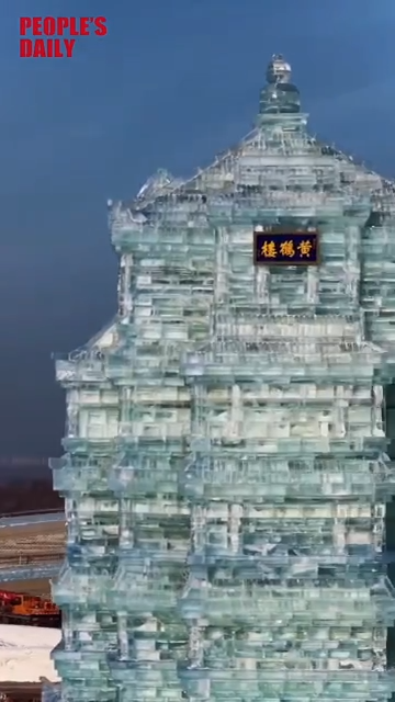 An ice sculpture of Wuhan's Yellow Crane Tower rises in snowy Harbin