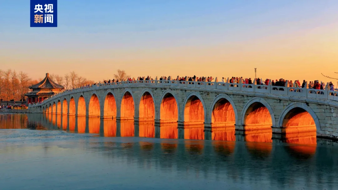 Golden sunlight streams through arches of Beijing's Seventeen-Arch Bridge