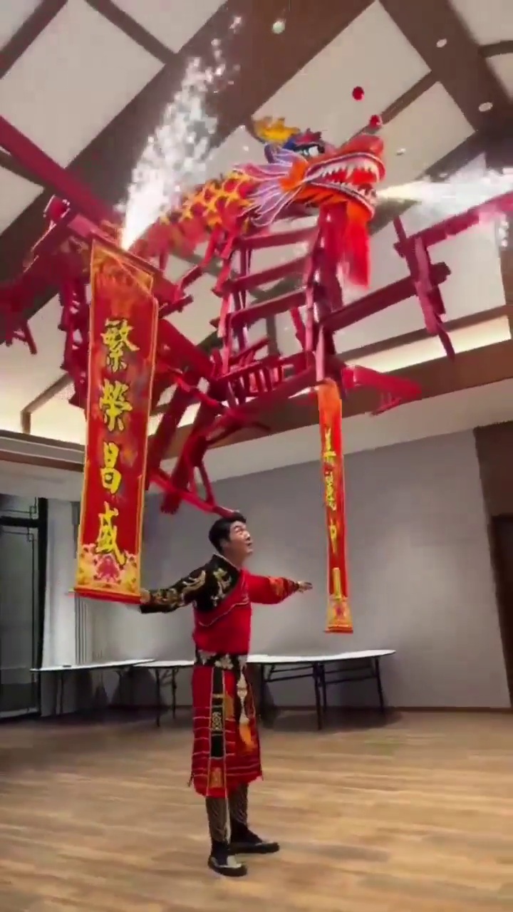 Acrobat balances dragon bench on head