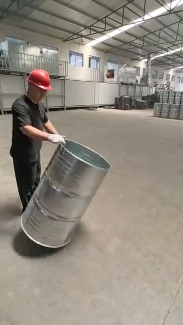 Warehouse worker spins oil drums with incredible precision