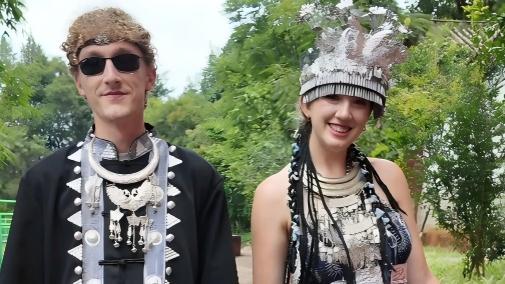 Dressed in ethnic splendor, Chinese and American youths sing and dance together
