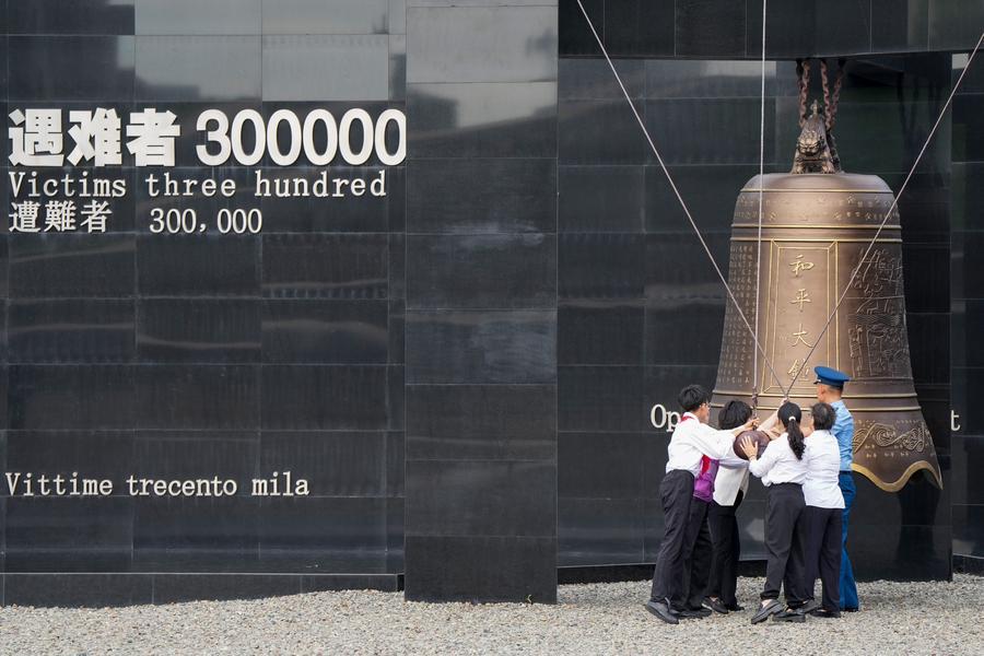 People strike the Bell of Peace during a ceremony marking the 89th anniversary of the beginning of China's whole-nation resistance war against Japanese aggression at the Memorial Hall of the Victims in Nanjing Massacre by Japanese Invaders in Nanjing, east China's Jiangsu Province, July 7, 2026. (Xinhua/Li Bo)
