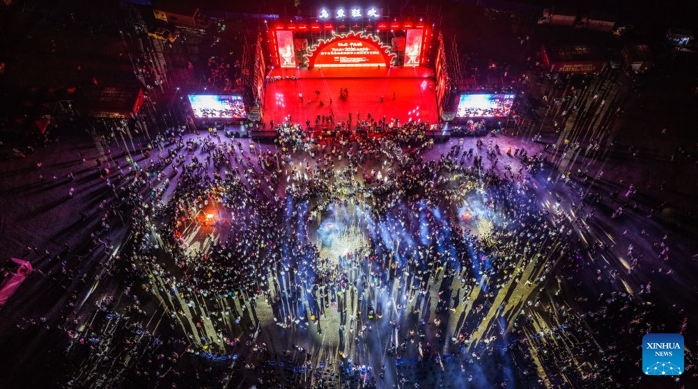 An aerial drone photo shows a bonfire party held in Yi-Hui-Miao Autonomous County of Weining, Bijie, southwest China's Guizhou Province, Aug. 6, 2026. The cool climate and rich tourism resources in Guizhou have attracted lots of visitors seeking a summer retreat. (Xinhua/Tao Liang)