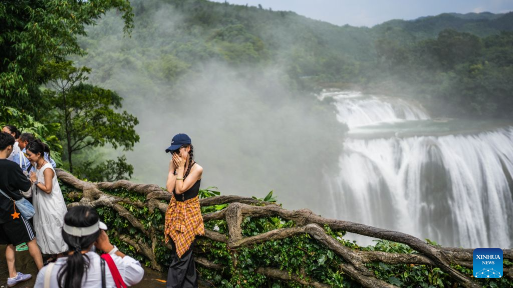 Tourists visit the Huangguoshu Waterfall in Anshun, southwest China's Guizhou Province, July 12, 2026. The cool climate and rich tourism resources in Guizhou have attracted lots of visitors seeking a summer retreat. (Xinhua/Tao Liang)