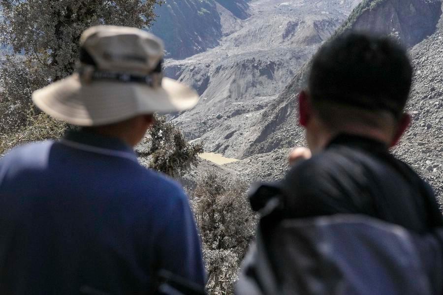 Experts conduct on-site surveys near a barrier lake formed upstream of the Gyirong Port in Gyirong County, southwest China's Xizang Autonomous Region, Aug. 28, 2026. (Xinhua/Jigme Dorje)