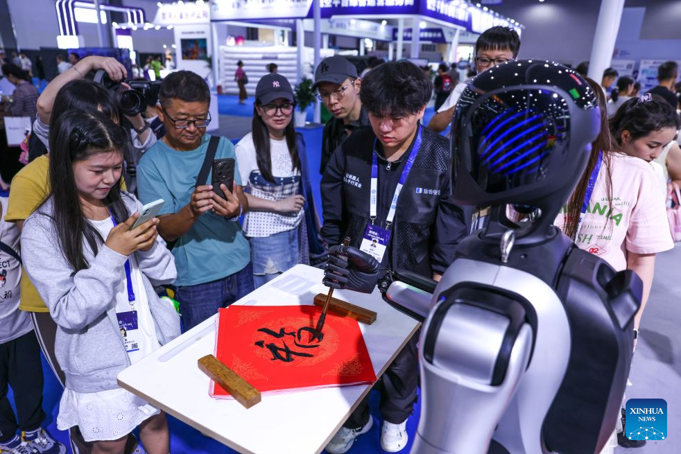 A robot writes calligraphy during the professional exhibition of the 2026 China International Big Data Industry Expo in Guiyang, southwest China's Guizhou Province, Aug. 28, 2026. Themed "Token: A New Path to Value of Data Elements," the expo spotlights cutting-edge innovations integrating data with artificial intelligence. (Xinhua/Yang Wenbin)