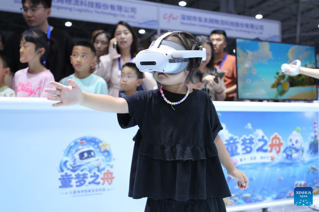 A child experiences a mixed reality (MR) device during the professional exhibition of the 2026 China International Big Data Industry Expo in Guiyang, southwest China's Guizhou Province, Aug. 28, 2026. Themed "Token: A New Path to Value of Data Elements," the expo spotlights cutting-edge innovations integrating data with artificial intelligence. (Xinhua/Li Xulun)