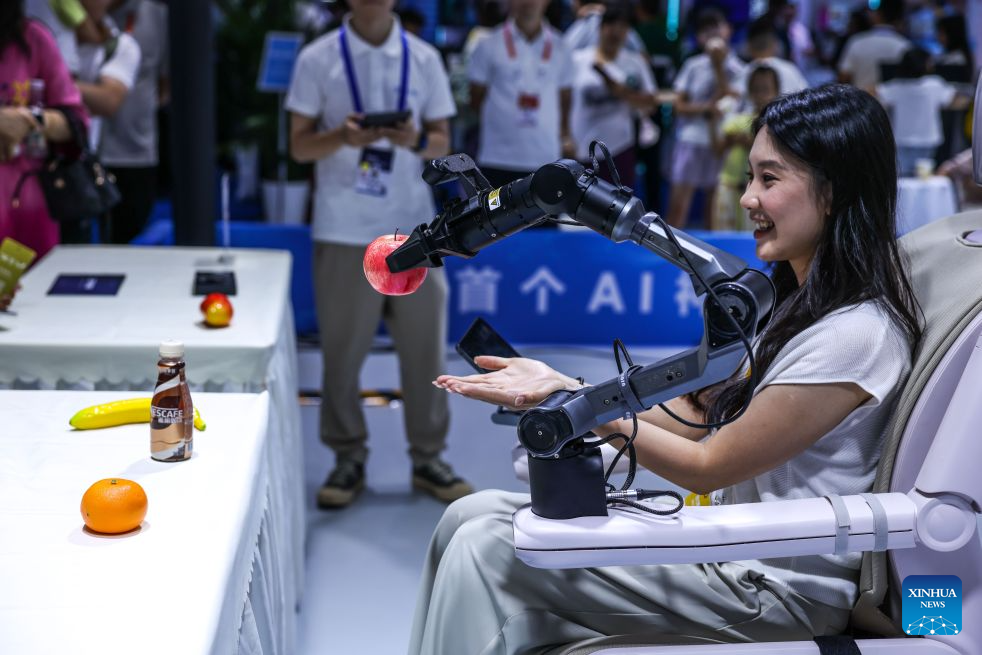 A journalist experiences a healthcare robot during the professional exhibition of the 2026 China International Big Data Industry Expo in Guiyang, southwest China's Guizhou Province, Aug. 28, 2026. Themed "Token: A New Path to Value of Data Elements," the expo spotlights cutting-edge innovations integrating data with artificial intelligence. (Xinhua/Yang Wenbin)